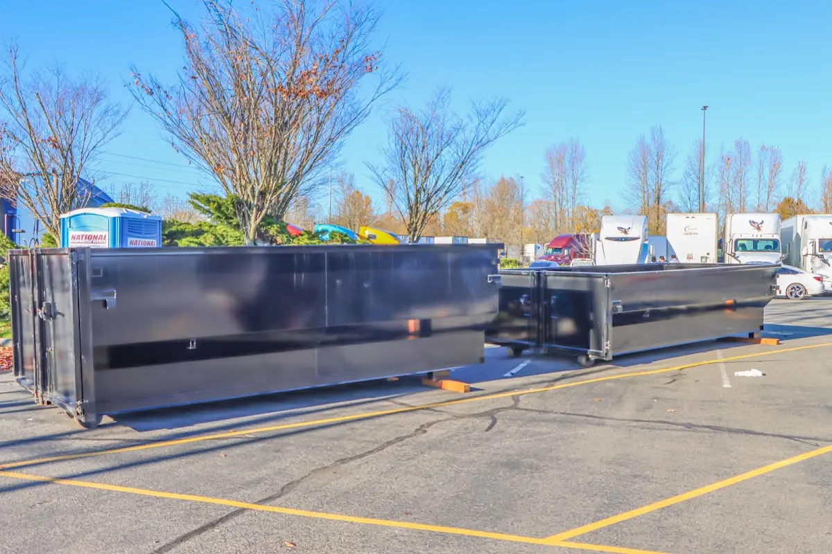 Professional dumpster rental service with roll-off container on residential driveway in North Manchester
